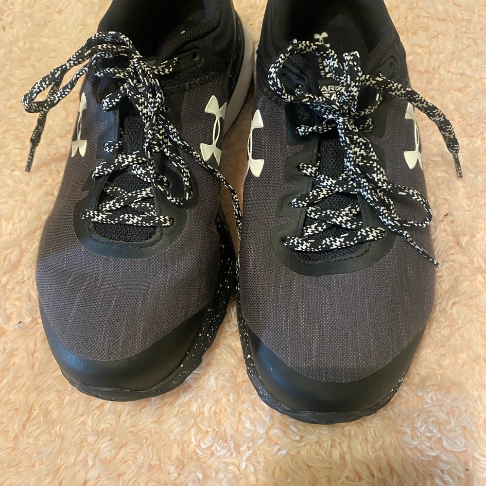 Size 8 black and white CHARGED Women’s game sneakers.